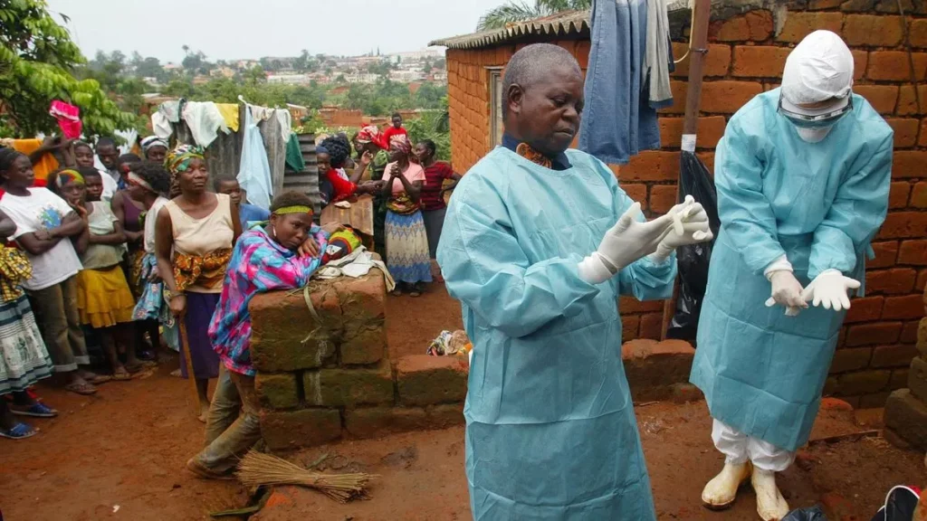 0 World Health Organisation officials examine the home of a suspected Marburg virus victim in the nort