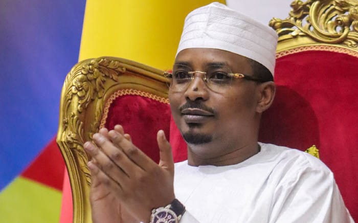 Idriss Deby applauds as he is sworn in as Chads transitional president