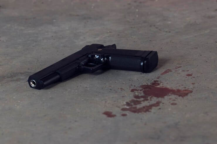 high angle view black handgun blood floor 1048944 27514528